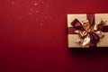 Luxury gold gift box with red and gold ribbon isolated on red background, top view, Christmas and Valentines day background.