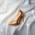 Luxury gold high-heel shoe on silk background Royalty Free Stock Photo