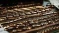 luxury gold jewelry chains, bracelets background, selective focus. Stylish beautiful bijouterie hanging on the stand in the Royalty Free Stock Photo