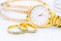 Luxury gold ring and lady gold watch on white Royalty Free Stock Photo