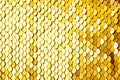 Luxury golden Background. Abstract Texture scales with gold Sequins close-up. Glamor Background with shiny Sequins on fabric,