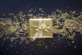 Luxury golden gift box with gold ribbon on shine black background. Christmas, birthday party present. Flat lay. Top view. Festive Royalty Free Stock Photo