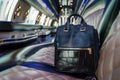 luxury handbagstyle backpack on a limousine seat, upscale interior Royalty Free Stock Photo