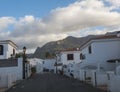 Luxury holiday apartments, white houses at hill above Puerto de las Nieves, popular seaside resort with view of Tamadaba