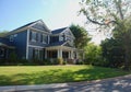 Luxury Home With Blue Siding and White Columns