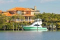 Luxury home and boat on the water Royalty Free Stock Photo