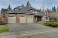 Luxury home exterior with three car garage. Royalty Free Stock Photo