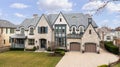 A luxury home with stone siding and brick driveway. Royalty Free Stock Photo