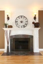 Luxury home white fireplace with stone and clock. Royalty Free Stock Photo