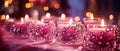 Luxury horizontal blurred magenta background with burning candles decorated with jewelry with gemstones. Close-up, bokeh