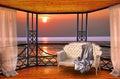 Luxury hotel balcony room with sunset ocean window view Royalty Free Stock Photo