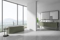 Luxury hotel bathroom interior with bathtub and double sink, panoramic window Royalty Free Stock Photo
