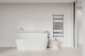 Luxury hotel bathroom interior with bathtub and towel rail, mockup wall Royalty Free Stock Photo