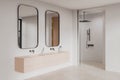 Luxury hotel bathroom interior with sink, mirror and douche, bathing accessories