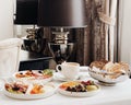 Luxury hotel and five star room service, various food platters, bread and coffee as in-room breakfast for travel and Royalty Free Stock Photo