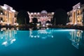 Luxury hotel front view with big pool, at night Royalty Free Stock Photo