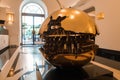 Luxury hotel lobby in Rome with large, golden sphere sculpture Royalty Free Stock Photo