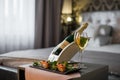 Luxury hotel room with a table with snacks and champagne glasses close up