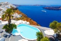 Luxury hotel with sea view. White architecture on Santorini island, Greece. Beautiful view on sea and cruise ship Royalty Free Stock Photo