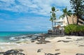 Luxury hotel on untouched sandy beach with palms trees and azure Royalty Free Stock Photo