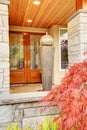 Luxury house entrance porch with stone column trim and wooden do Royalty Free Stock Photo