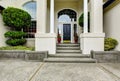 Luxury house entry way exterior with concrete floor porch. Royalty Free Stock Photo