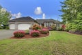 Luxury house exterior with brick trim, tile roof and french windows.