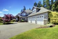 Luxury house exterior with french windows and three space parking garage. Royalty Free Stock Photo