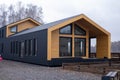 Luxury house of new construction in loft style. The modern-style house boasts a two-car garage, framed siding and Royalty Free Stock Photo