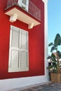 Luxury house outdoor garden. Close up of the old red house ancient window with white shutters, wrought iron, thick. Wall of Royalty Free Stock Photo