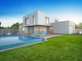 Luxury house with swimming pool and terrace near lawn in modern design, Empty front yard at vacation home or holiday villa Royalty Free Stock Photo