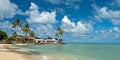 Luxury house on untouched sandy beach with palms trees and azure Royalty Free Stock Photo