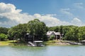 Luxury houses built beside lake with docks and little beaches among the trees