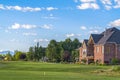 Luxury houses and golf course with mountain and blue sky in the background Royalty Free Stock Photo