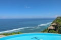 Luxury infinity pool with sea views and palm trees. Bali, Indonesia Royalty Free Stock Photo