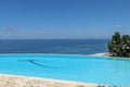 Luxury infinity pool with sea views and palm trees. Bali, Indonesia Royalty Free Stock Photo