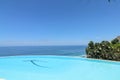 Luxury infinity pool with sea views and palm trees. Bali, Indonesia Royalty Free Stock Photo