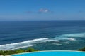 Luxury infinity pool with sea views and palm trees. Bali, Indonesia Royalty Free Stock Photo