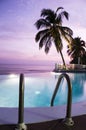 Luxury infinity swimming pool caribbean sunset Royalty Free Stock Photo