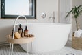 Luxury interior in bathroom with bathtub and beauty products for bodycare Royalty Free Stock Photo