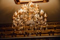 Luxury interior chandelier has light candles.