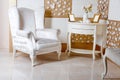 Luxury Interior. Luxurious white armchair, antique carved furniture, classic room interior detail. Royalty Free Stock Photo