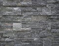 Luxury interior wall cladding made of dark gray natural stone.