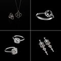 Luxury jewellery set. White gold or silver rings, earrings with crystals and pendant isolated on black. Selective focus. Royalty Free Stock Photo