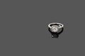 Luxury jewellery. White gold or silver ring isolated on gray background. Selective focus. Royalty Free Stock Photo