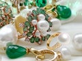 Luxury jewelry Emerald greeen white pearl gold rings and earing jewelry on white background Royalty Free Stock Photo