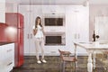 Luxury kitchen with marble table red fridge, woman Royalty Free Stock Photo