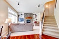 Luxury large beige living room with staircase.