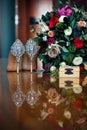 Luxury leather high-heeled shoes decorated with rhinestones, vertical photo. Wedding shoes, bouquet of beautiful roses, gold rings