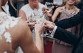 luxury life concept. champagne and wine glasses in hands at luxury wedding reception at restaurant. guests toasting and cheering Royalty Free Stock Photo